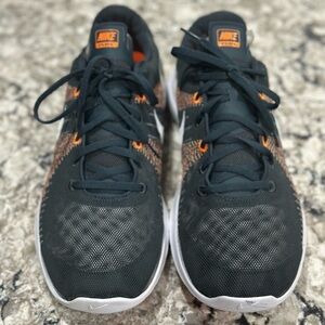 Nike Black and Orange Athletic Shoes with Textured Design